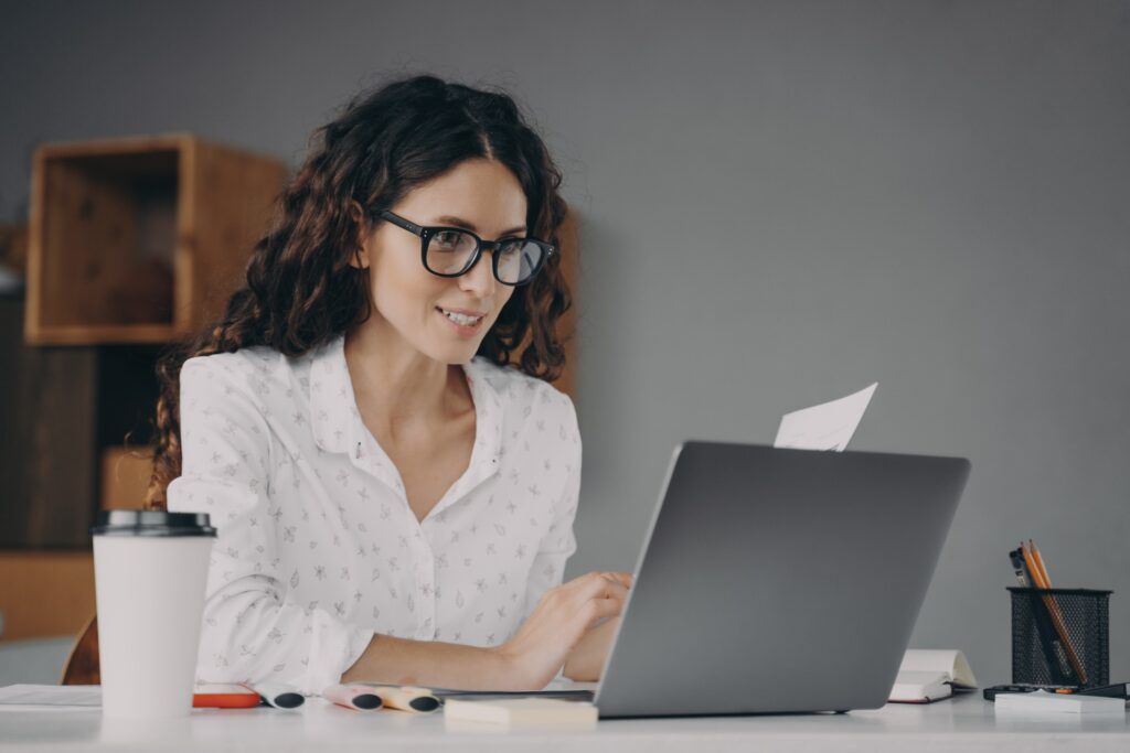 Woman In Glasses Working On Laptop From Home