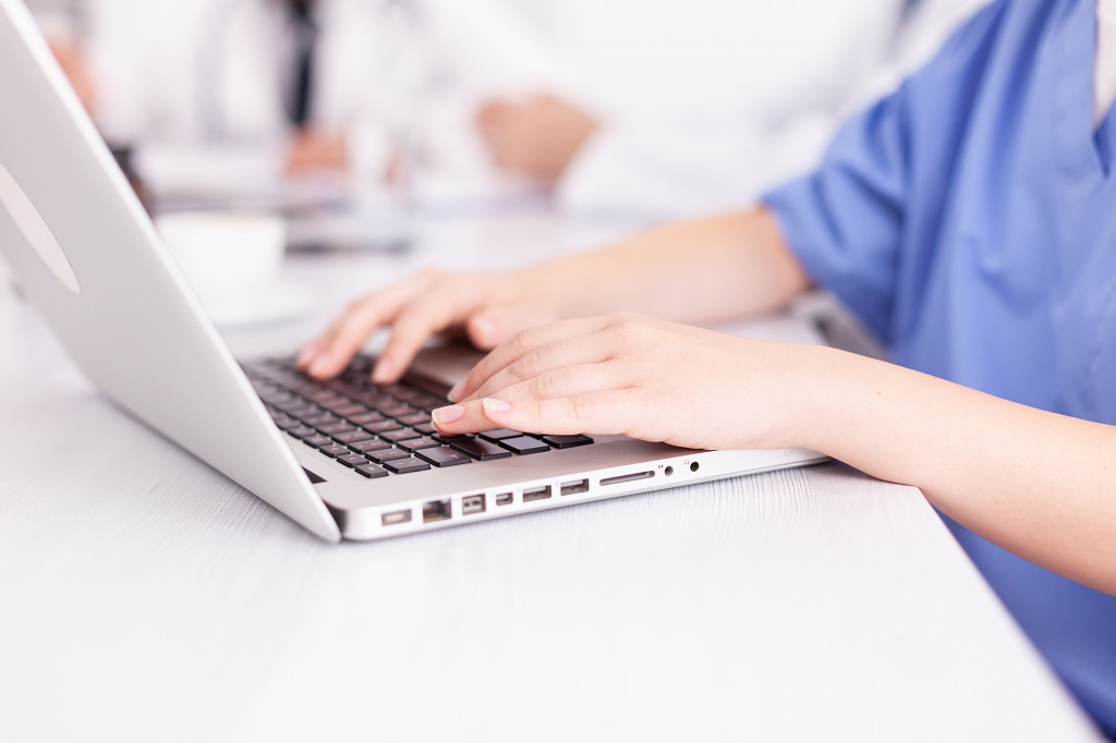 A Closeup Photo Of An Aspiring Nurse Working On Her Nursing Cover Letter Using A Laptop
